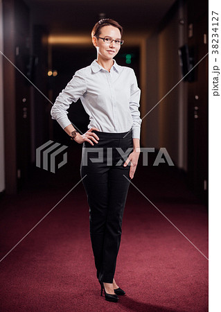 businesswoman standing in office building businesswoman standing in office building 38234127