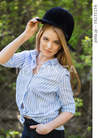 girl in riding clothes and helmet on a light 38235156