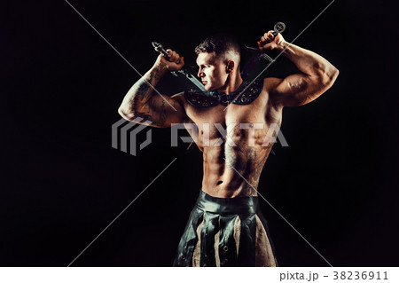Severe barbarian in leather costume with sword 38236911
