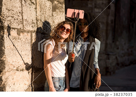Two attractive girls wearing casual closes and 38237035