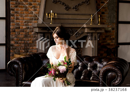 Bride in white dress sitting on chair Bride in white dress sitting on chair 38237168