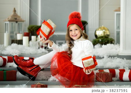 Portrait of a happy girl opening gift box 38237591