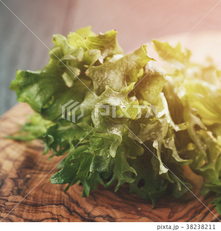fresh green frillis salad on cutting board fresh green frillis salad on cutting board 38238211