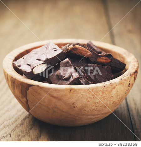 homemade chocolate with almonds in wood bowl homemade chocolate with almonds in wood bowl 38238368