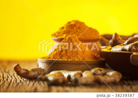 Turmeric roots on wooden background Turmeric roots on wooden background 38239387