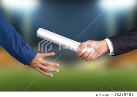 Businessman passing relay baton to colleague 38239483