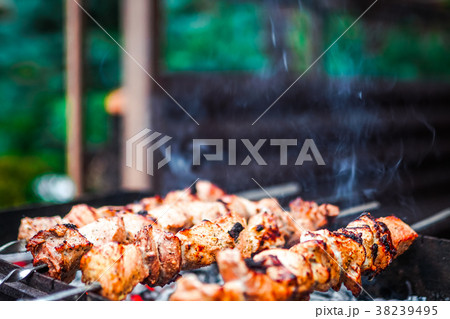 Grilled kebab cooking on metal skewer. Roasted Grilled kebab cooking on metal skewer. Roasted 38239495