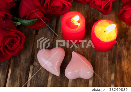 Two burning candles with fresh roses Two burning candles with fresh roses 38240886