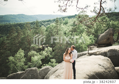 Wedding couple in love kissing and hugging near Wedding couple in love kissing and hugging near 38242607