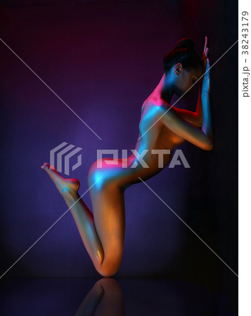 Elegant nude model in the light colored spotlights Elegant nude model in the light colored spotlights 38243179