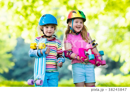 Children riding skateboard in summer park 38243847