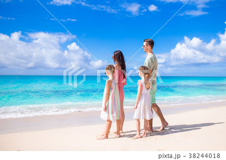 Happy family with kids walk on the beach Happy family with kids walk on the beach 38244018