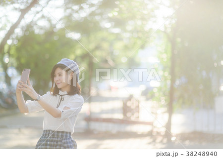 Young attractive woman relaxing and use phone Young attractive woman relaxing and use phone 38248940