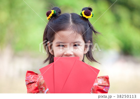 Cute asian child girl holding red envelope Cute asian child girl holding red envelope 38250113
