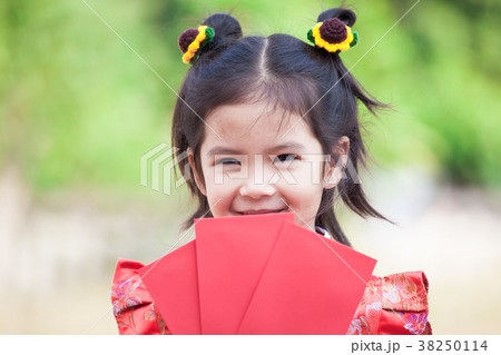 Cute asian child girl holding red envelope Cute asian child girl holding red envelope 38250114