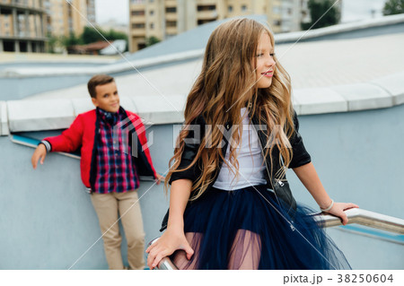 Two kids: Beautiful Children play on the railing Two kids: Beautiful Children play on the railing 38250604