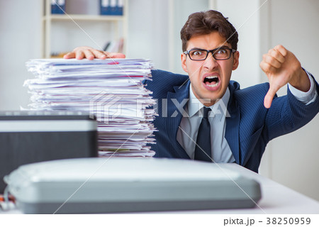 Businessman making copies in copying machine Businessman making copies in copying machine 38250959