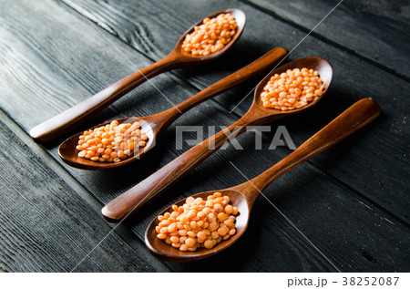 Spoons filled with uncooked lentil for soup Spoons filled with uncooked lentil for soup 38252087