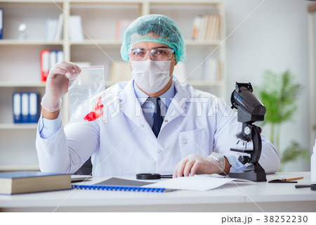 Forensics investigator working in lab on crime 38252230