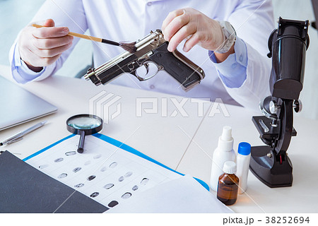 Criminologist police chemist looking at crime 38252694