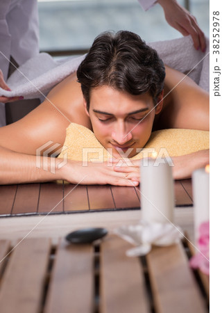 Young handsome man during spa procedure Young handsome man during spa procedure 38252978