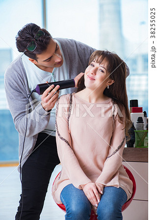 Man stylist working with woman in beauty salon Man stylist working with woman in beauty salon 38255025