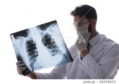 Young doctor looking at x-ray images isolated on 38256031