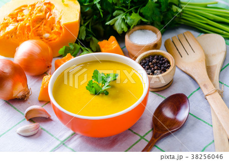 Pumpkin soup served on the table in bowl 38256046