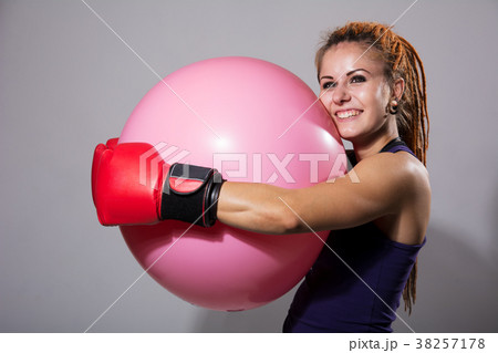 Young woman boxer with big rubber ball Young woman boxer with big rubber ball 38257178