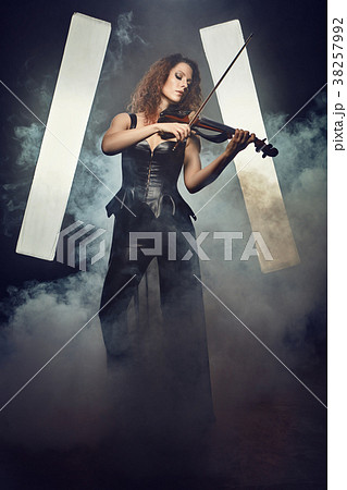 Violinist girl performs on stage. 38257992