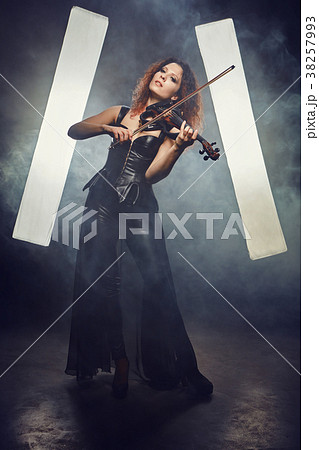 Violinist girl performs on stage. 38257993