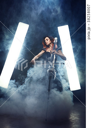 The cellist girl performs on stage. The cellist girl performs on stage. 38258007