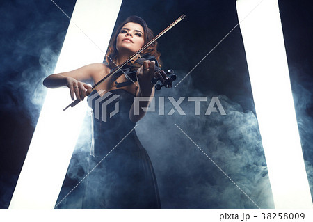 A girl plays the viola performs on stage. 38258009