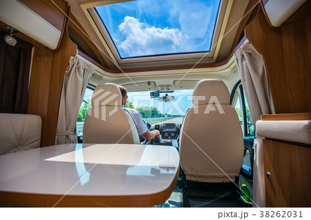 Man driving on a road in the Camper Van RV 38262031