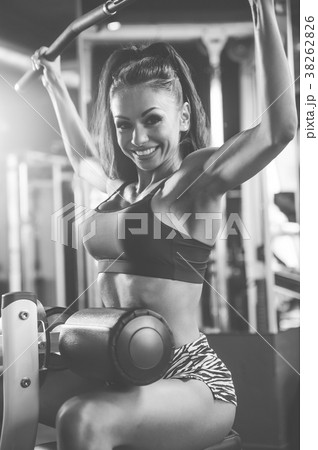 Sexy athletic young girl training back in gym Sexy athletic young girl training back in gym 38262826