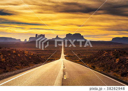 Desert road leading to Monument Valley at sunset Desert road leading to Monument Valley at sunset 38262948