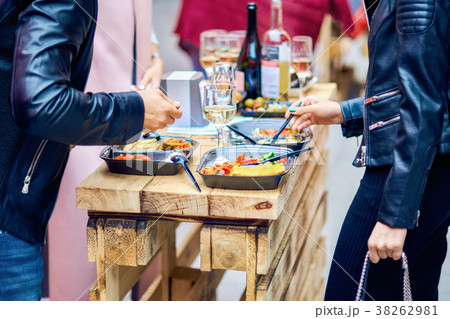 A man and a woman eat street food. A man and a woman eat street food. 38262981