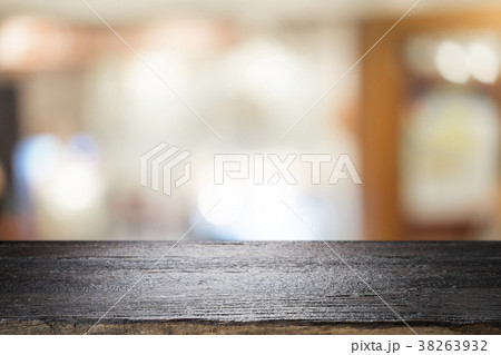 Wooden table with blur background of coffee cafe. 38263932