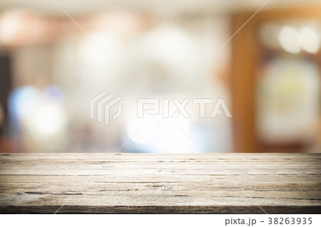 Wooden table with blur background of coffee cafe. 38263935