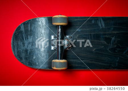used skateboard on a red background 38264550