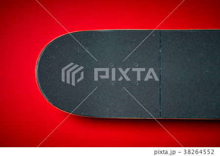 used skateboard on a red background 38264552