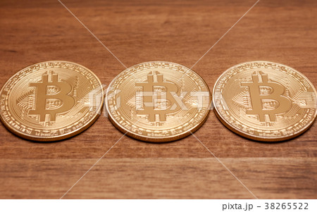 three golden bitcoin coins 38265522