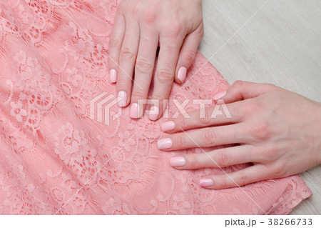 Lace pink  blouse and female hands. Pink manicure 38266733