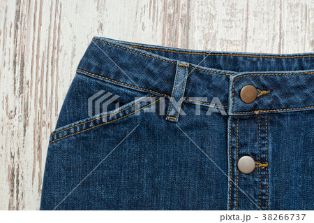 Part of the blue denim skirt. Wooden background 38266737