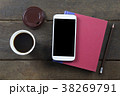 Empty screen mobile on red cover book and pencil  38269791