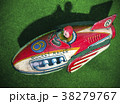 retro rocket tin toy close up on green felt 38279767