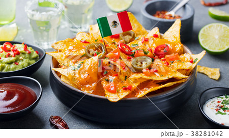 Nachos chips with Mexican flag and dips variety. 38281042