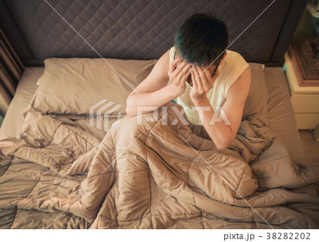 Asian man suffering from depression on bed 38282202