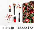 Woman cosmetics and top decorated. Flat lay in red 38282472