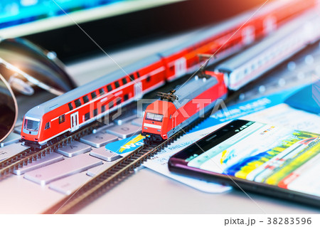 Toy train tickets passport and bank card on laptop 38283596